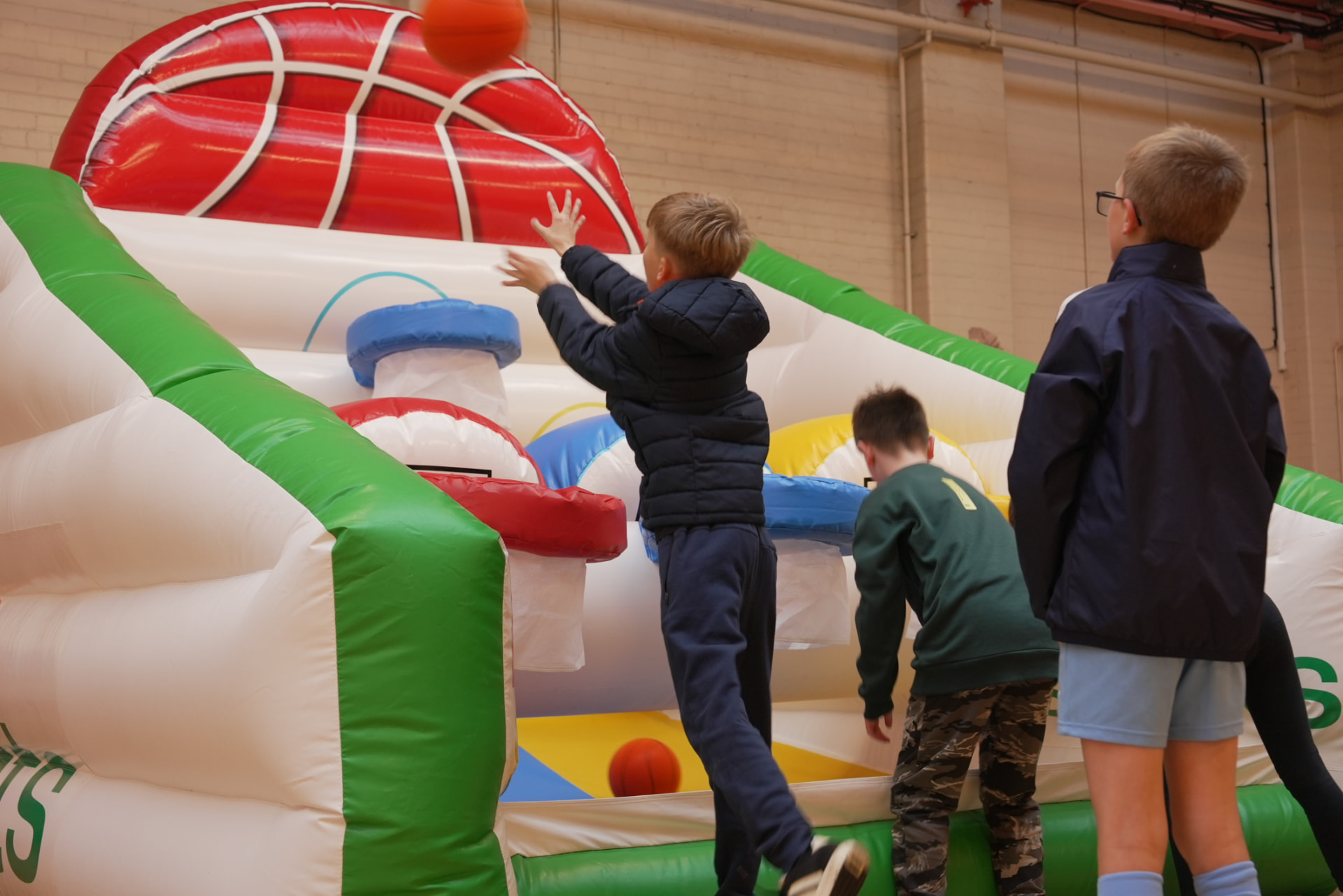 Kids queuing to play the inflatable basketball shootout