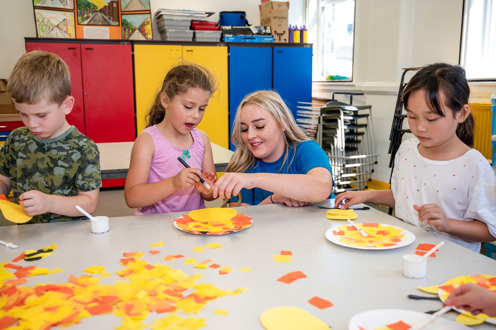 BDM coach helping children with a hands on activity
