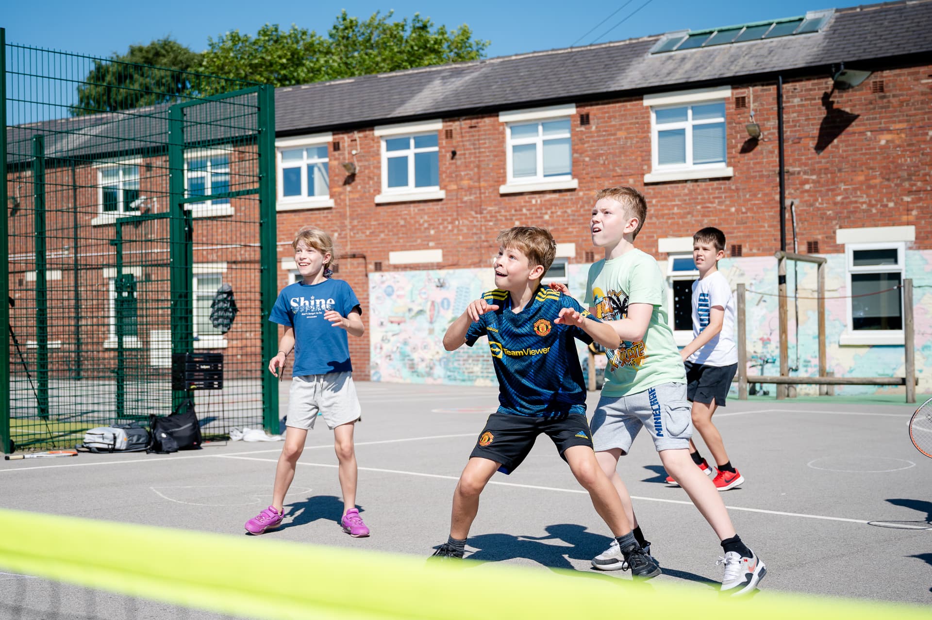 Children playing a tennis game on the playground